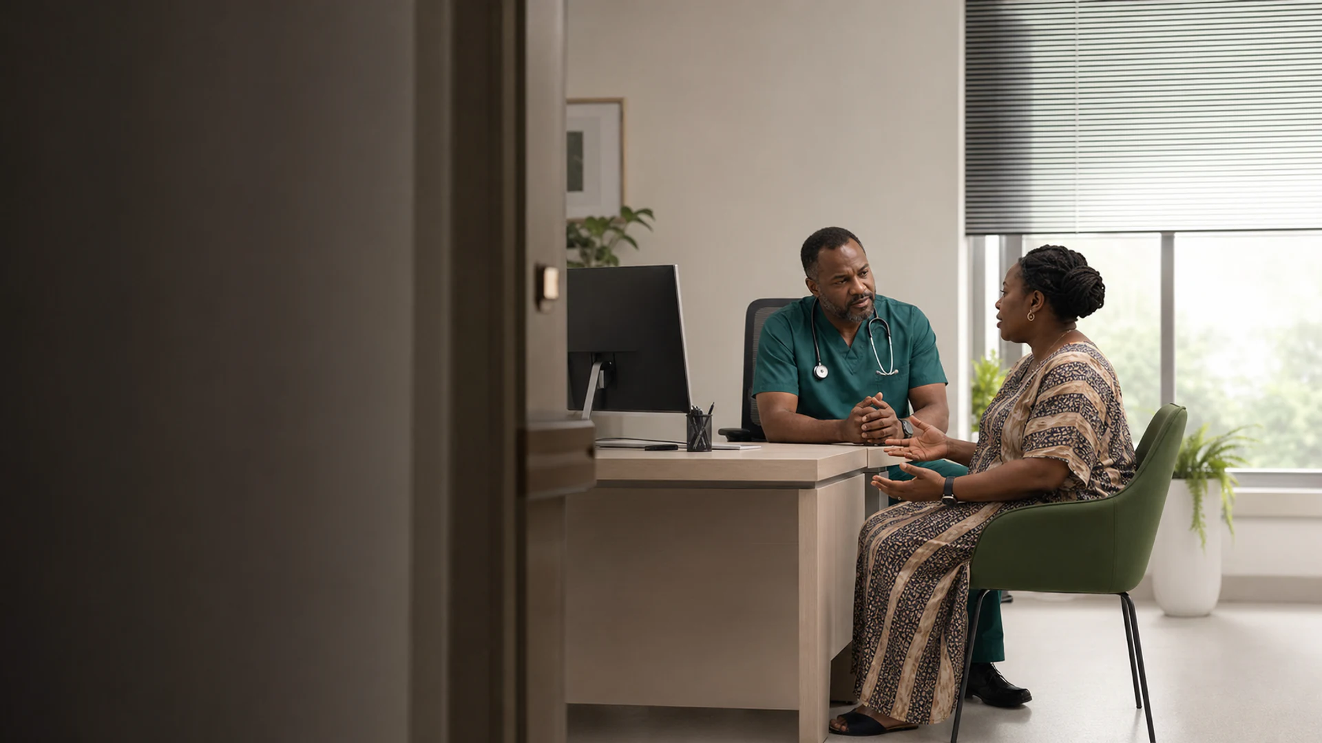 A consultant in discussion with a patient in a Care & Cure consulting room